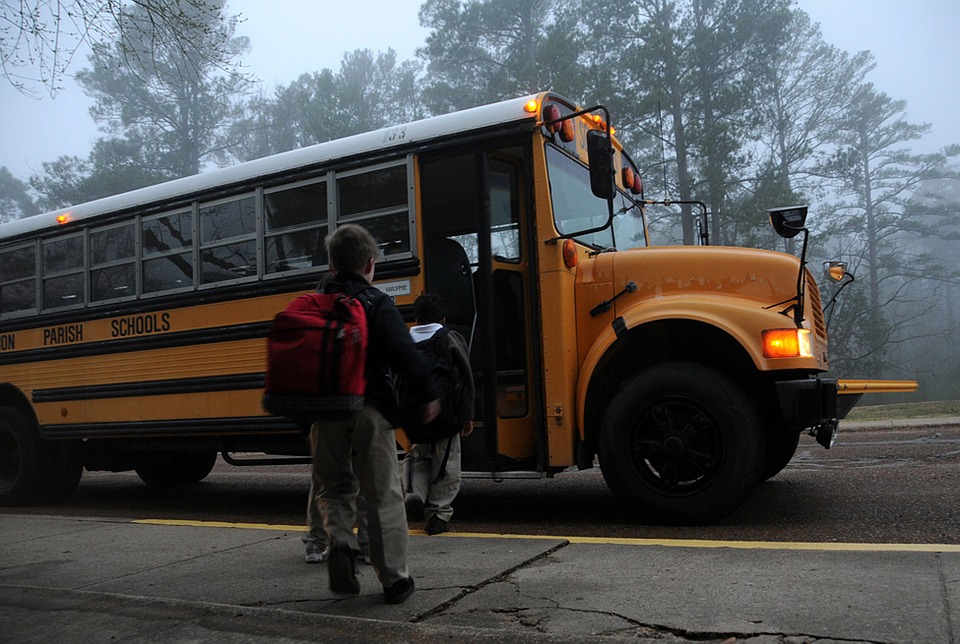 An image of a schoolchildren boarding an American school bus